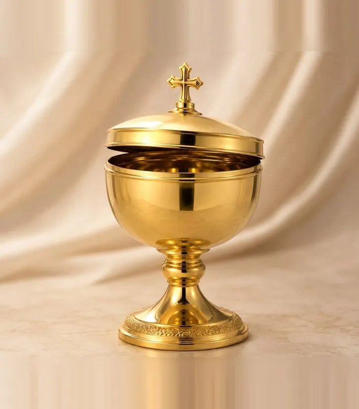 Gold-plated thurible with a cross-surmounted lid and chains, on a marble surface